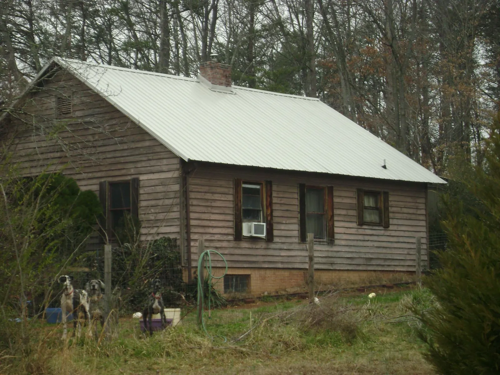 White metal roof on an old wood sided farmhouse, from a Metal Roof Installation job in Tehuacana